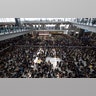 Protesters surround banners that read: "Those on the street today are all warriors!" and "Release all the detainees!" during a sit-in rally at the arrival hall of the Hong Kong International airport in Hong Kong, Aug. 12, 2019. 