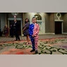9-year-old Reed Elliotte stands in the back of the room in a U.S. flag outfit with his mother Larrietta listening to U.S. President Donald Trump address the AMVETS American Veterans convention in Louisville, Aug. 21, 2019. 