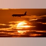 An aircraft passes the sun as it approaches the international airport in Frankfurt, Germany, Aug. 8, 2019.