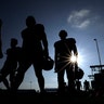 Houston Texans' players walk across a practice field before the start of a joint NFL training camp football practice with the Detroit Lions in Houston, Aug. 15, 2019. 