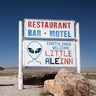 Sign for Little A'Le'Inn and flying saucer hanging from tow truck, Rachel, Nevada, near Area 51.