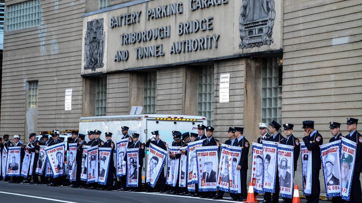 FDNY firefighters at the Tunnel to Towers race hold banners honoring fellow firefighters who were killed on 9/11. (Courtesy of Tunnel to Towers Foundation/Clare Photography)