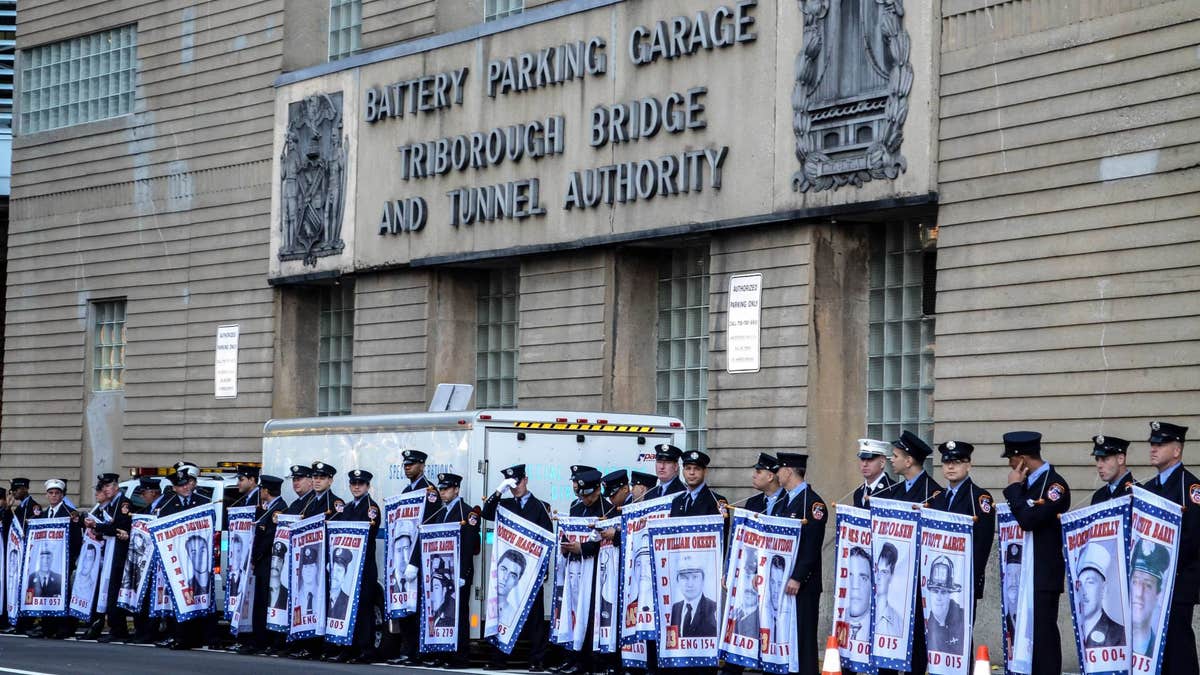 FDNY firefighters at the Tunnel to Towers race hold banners honoring fellow firefighters who were killed on 9/11. (Courtesy of Tunnel to Towers Foundation/Clare Photography)