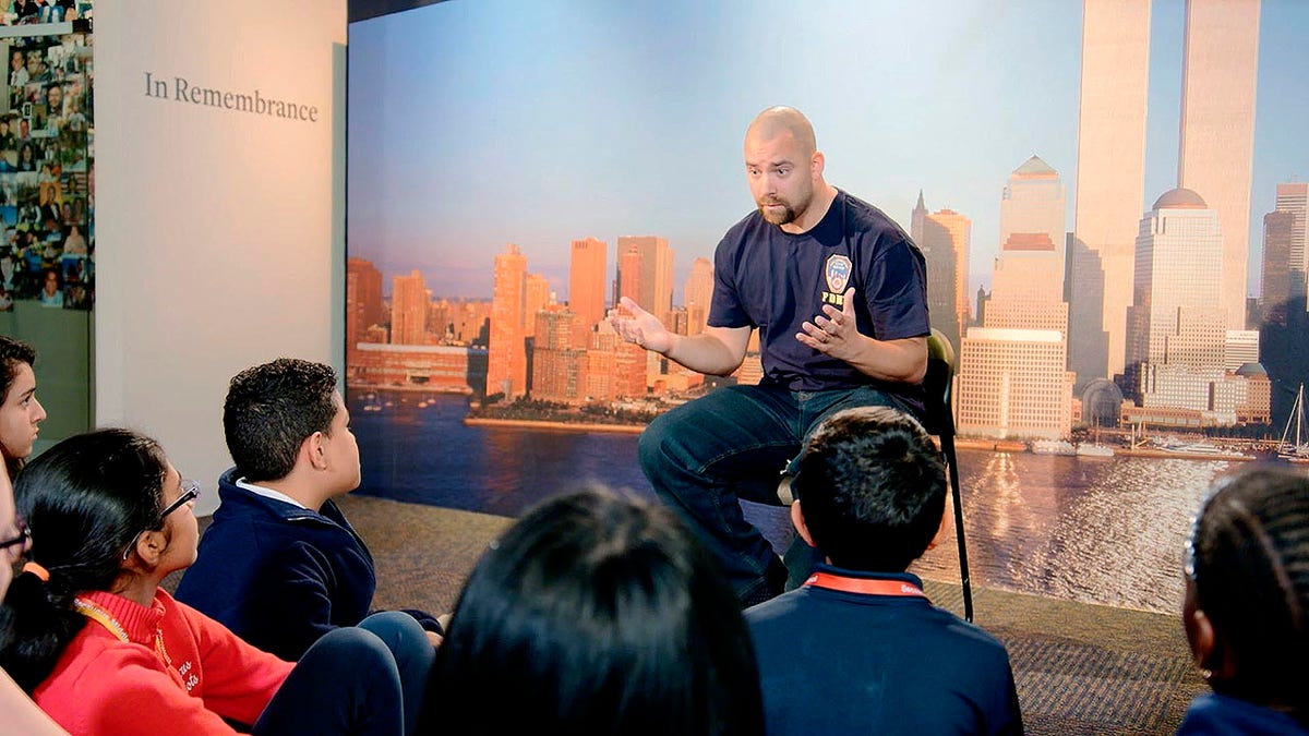 This image released by HBO shows a New York City Fireman speaking to children in a scene from the documentary 