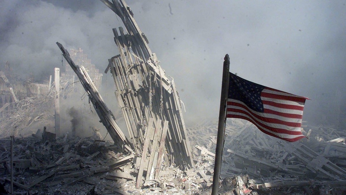 An American flag flies near the base of the destroyed World Trade Center in New York, in this photo from September 11, 2001, taken after the collapse of the towers. (REUTERS/Peter Morgan-File)