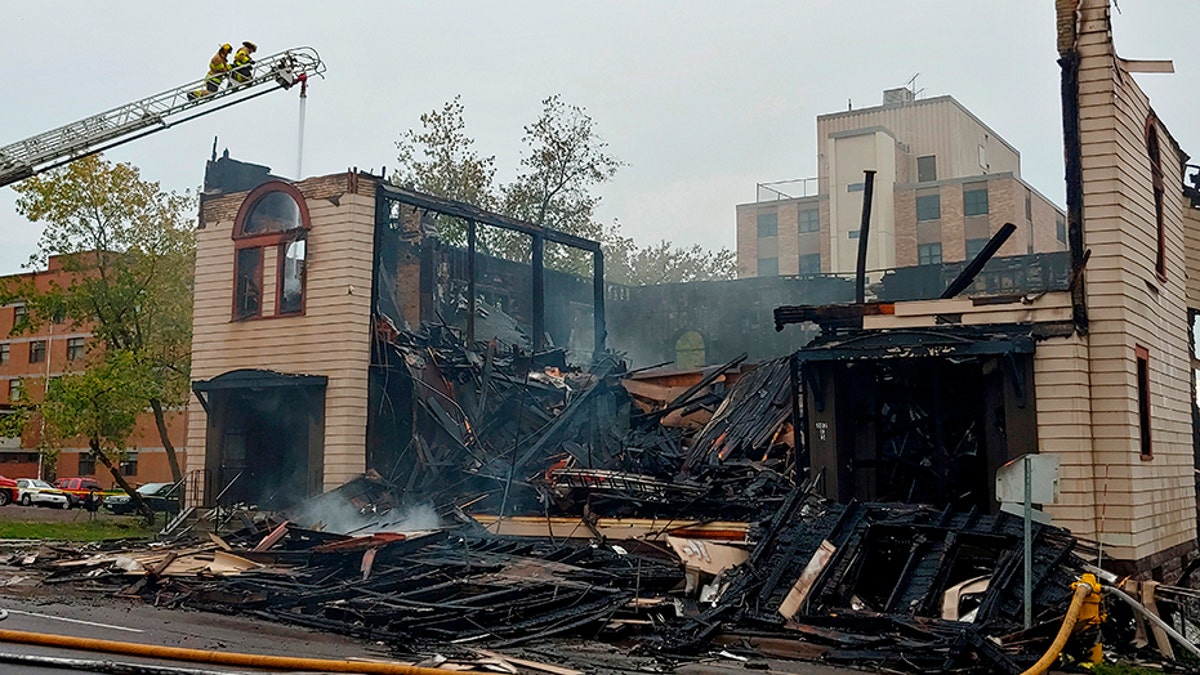 Firefighters working the scene of the fire that engulfed and destroyed a synagogue in downtown Duluth this past Monday. (Brooks Johnson/Star Tribune via AP)