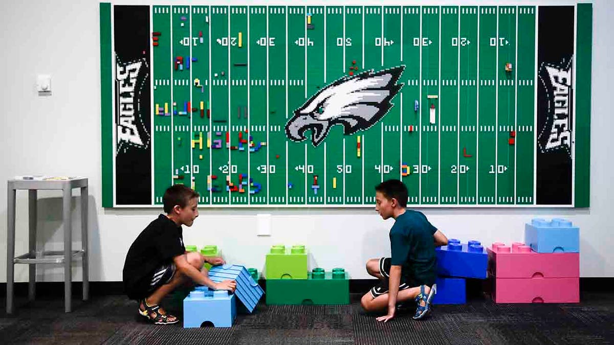 In this Thursday, Aug. 22, 2019, photo, 10-year-old twin brothers Ryan left, and Jack Ykoruk, play in the Lincoln Financial Field sensory room before a preseason NFL football game between the Philadelphia Eagles and the Baltimore Ravens in Philadelphia. (AP Photo/Matt Rourke)