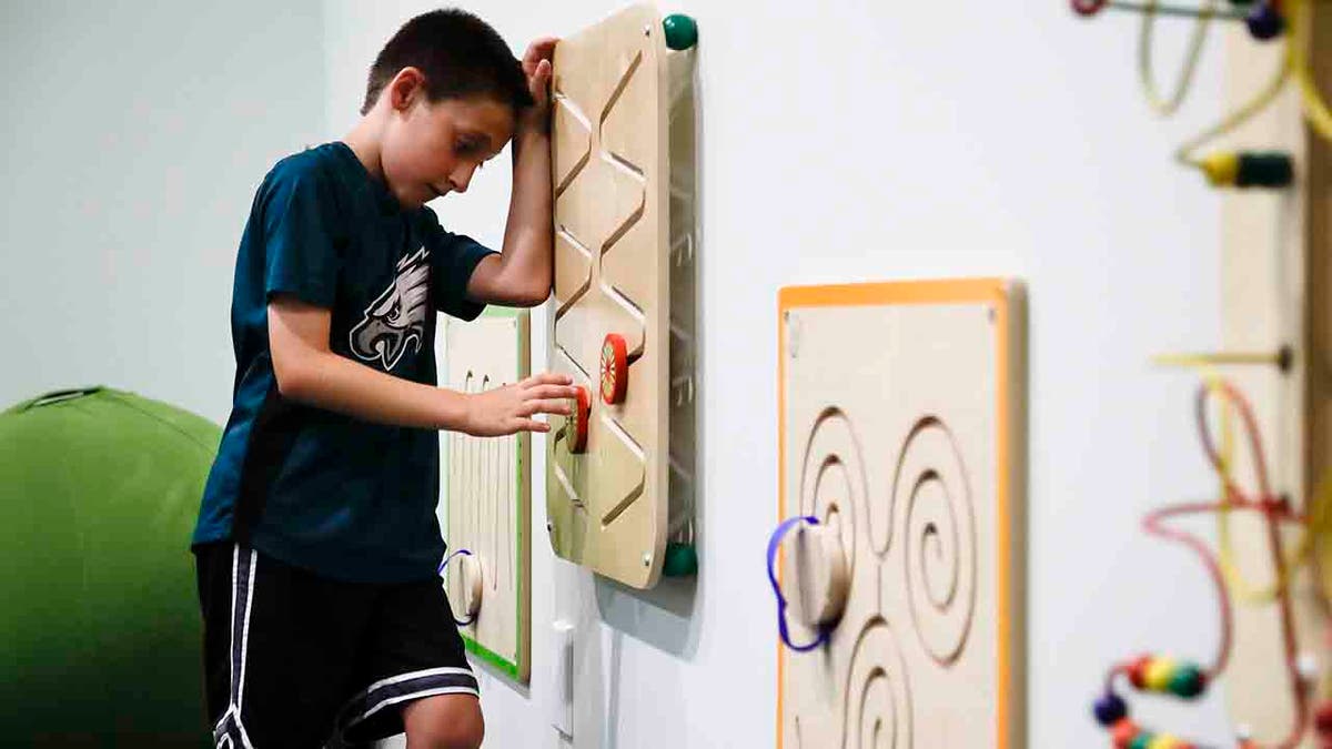 In this Thursday, Aug. 22, 2019, photo, 10-year-old Jack Ykoruk plays in the Lincoln Financial Field sensory room before a preseason NFL football game between the Philadelphia Eagles and the Baltimore Ravens in Philadelphia. (AP Photo/Matt Rourke)