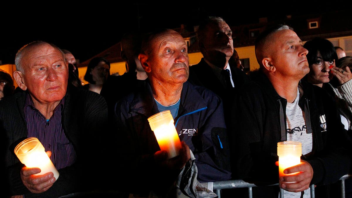 Spectators hold candles in their hands at the memorial service during ceremony marking 80th anniversary of World War II start at the exact place and time when Nazi Germany dropped its first bombs in the war, in Wielun, Poland, Sunday, Sept. 1, 2019. Observances in Warsaw will be attended by U.S. Vice President Mike Pence, in place of invited President Donald Trump.(AP Photo/Czarek Sokolowski)