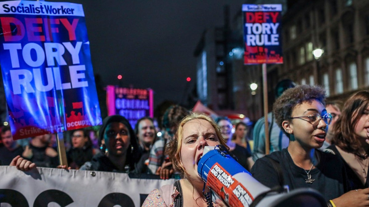 Protesters outside the House of Commons in London on Tuesday. (AP Photo/Vudi Xhymshiti)