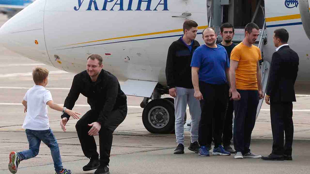 Ukraine's President Volodymyr Zelenskiy, right, greets Ukrainian prisoners upon their arrival at Boryspil airport, outside Kyiv, Ukraine, Saturday, Sept. 7, 2019.