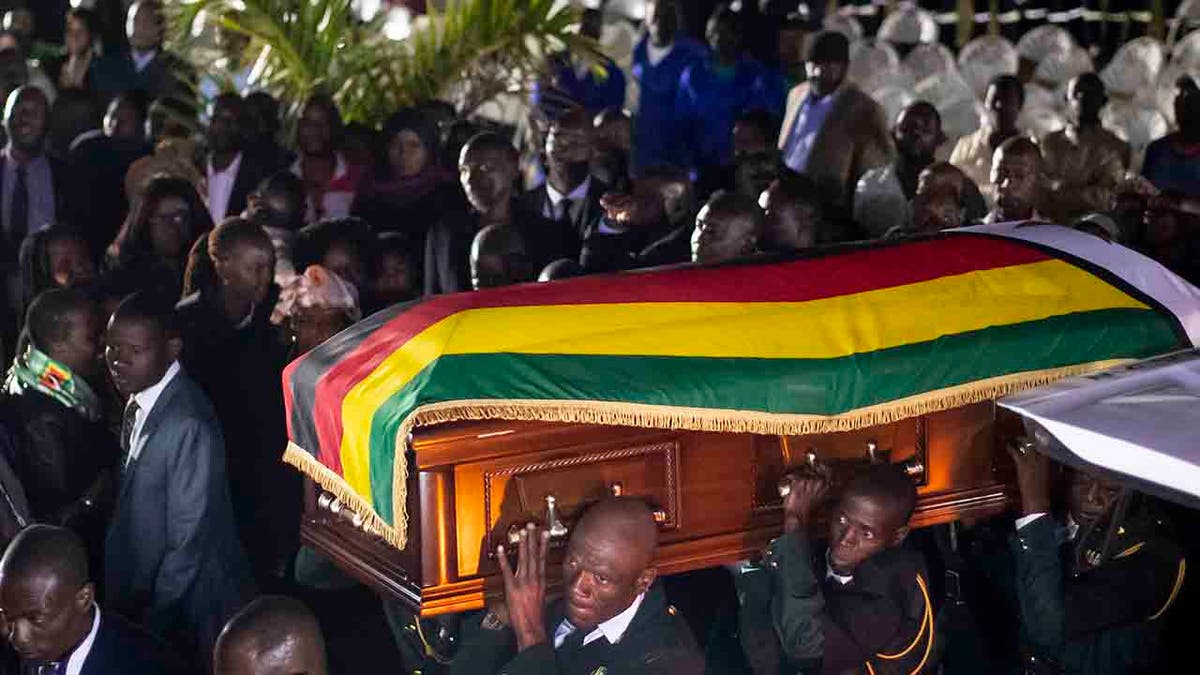 The body of former president Robert Mugabe arrives to lie in state inside his official residence in the capital Harare, Zimbabwe Wednesday, Sept. 11, 2019. 