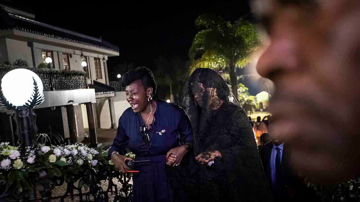 Widow Grace Mugabe, center, wears a black veil as she follows the coffin of former president Robert Mugabe, as it arrives to lie in state inside his official residence in the capital Harare, Zimbabwe Wednesday, Sept. 11, 2019. 