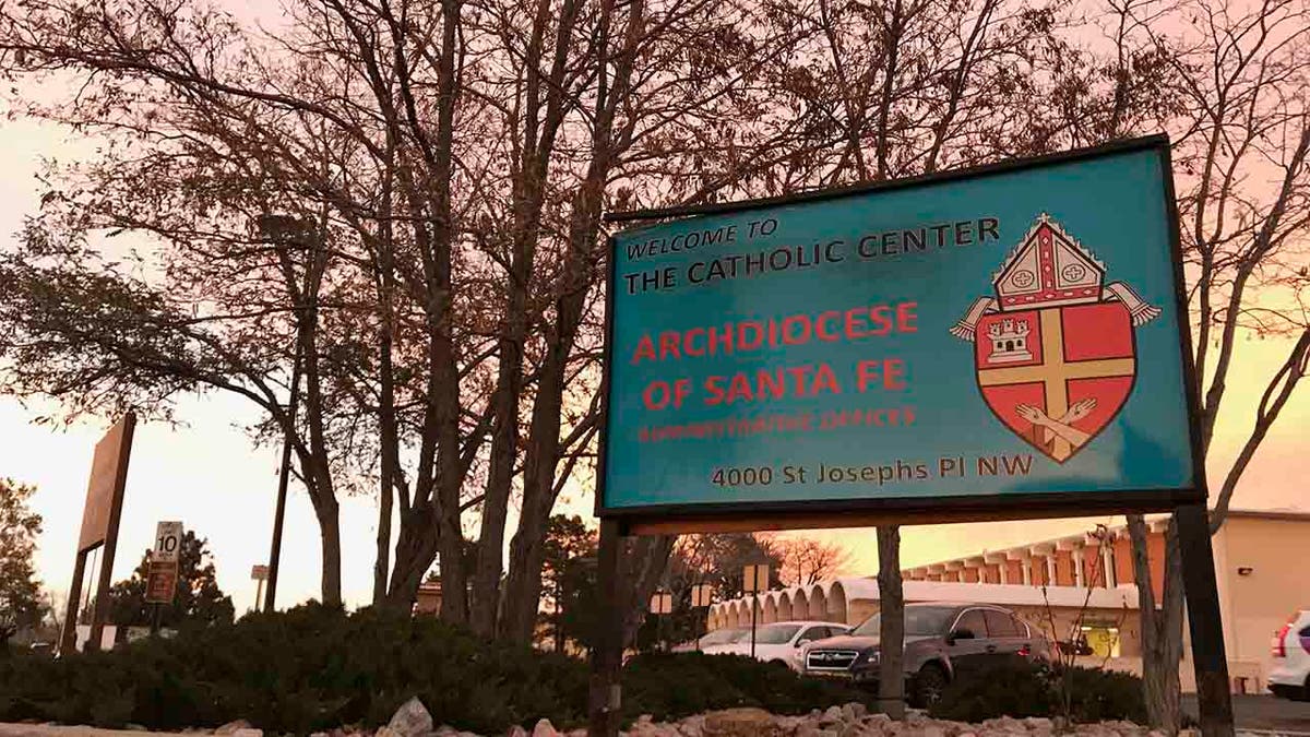 In this Nov. 29, 2018, file photo, the sun sets on a sign in front of the Archdiocese of Santa Fe offices in Albuquerque, N.M. A former Roman Catholic priest found guilty of sexual abuse in New Mexico is scheduled to be sentenced Friday, Sept. 13, 2019, in Santa Fe, N.M.
