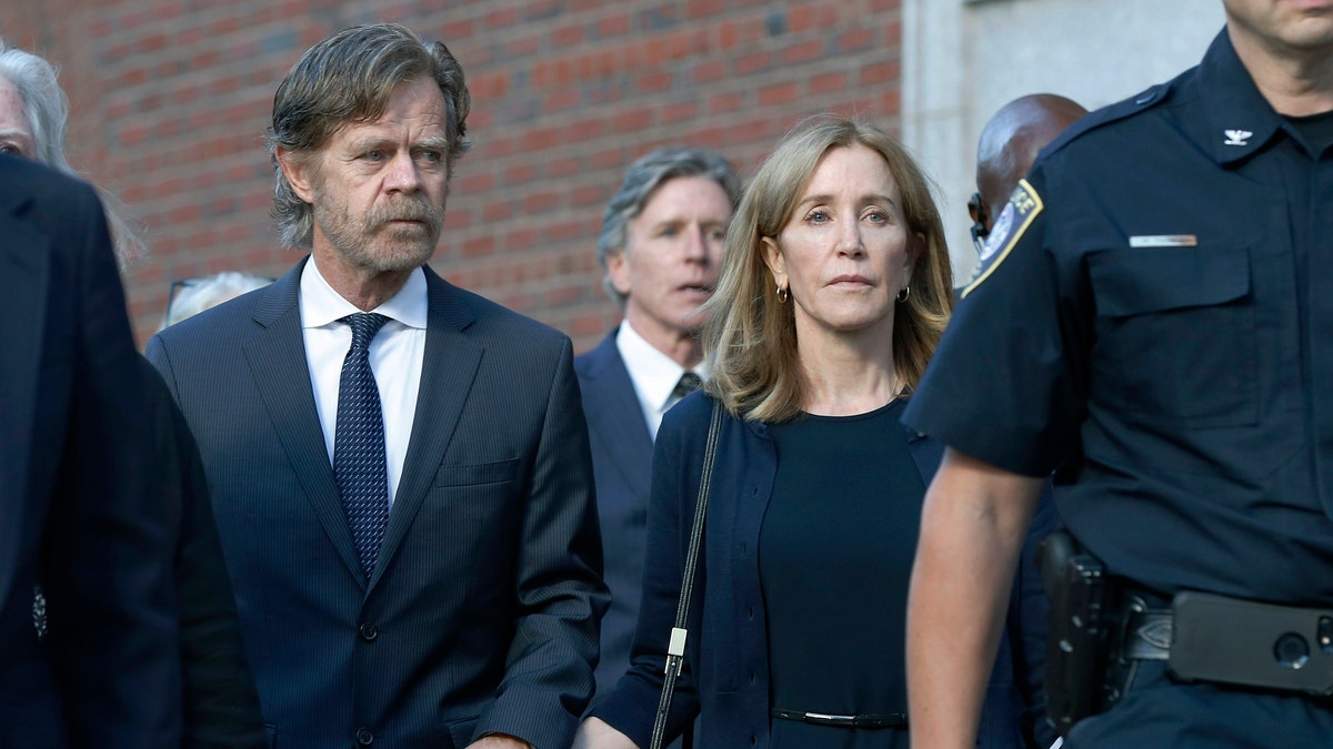 Felicity Huffman leaves federal court with her husband William H. Macy, left, and her brother Moore Huffman Jr. rear center, after she was sentenced in a nationwide college admissions bribery scandal, Friday, Sept. 13, 2019, in Boston. (AP Photo/Michael Dwyer)
