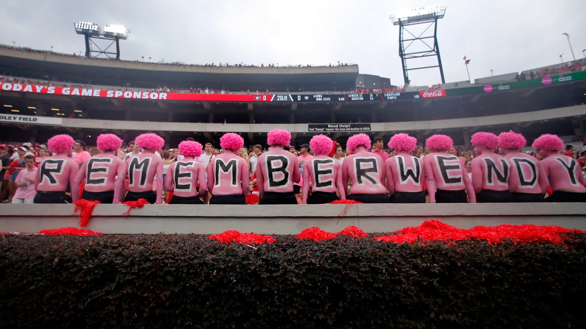 Georgia fans observe a moment of silence in horror of Wendy Anderson, wife of Arkansas State head coach Blake Anderson before an NCAA college football game Saturday, Sept. 14, 2019, in Athens, Ga. Fans were encouraged to "pink out" the stadium for Wendy Anderson who died from breast cancer in August. (AP Photo/John Bazemore)