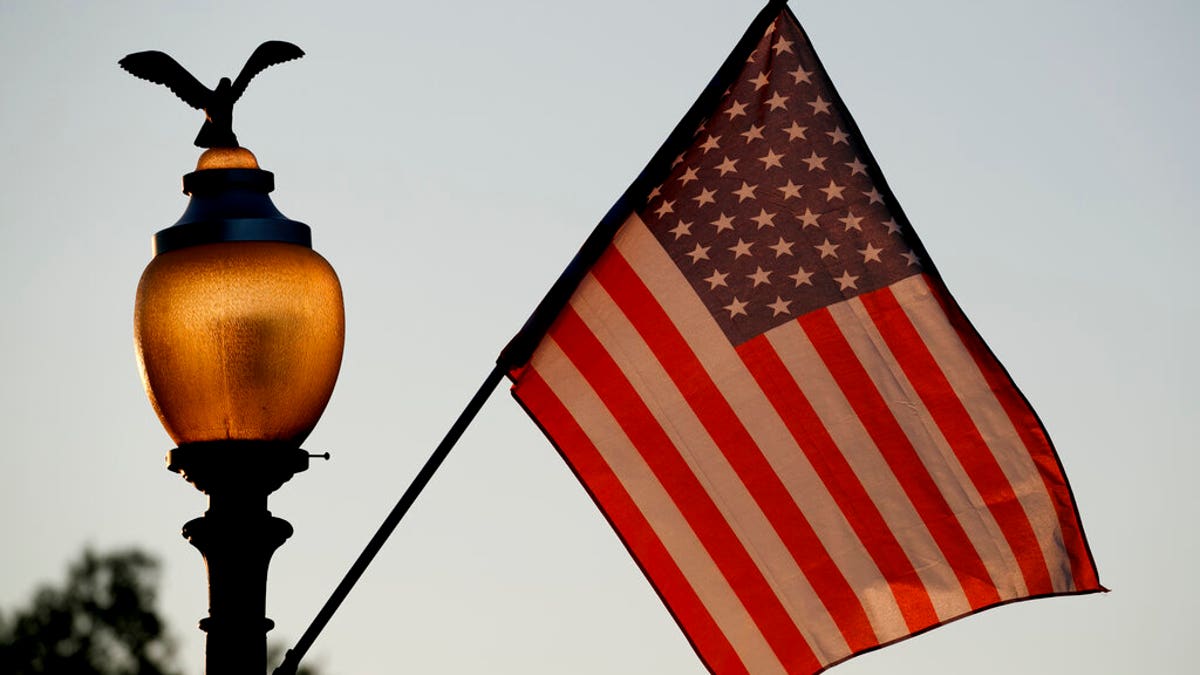 Flags fly at sunset with 51 instead of the usual 50 stars, along Pennsylvania Avenue, part of a display in support of statehood for the District of Columbia.