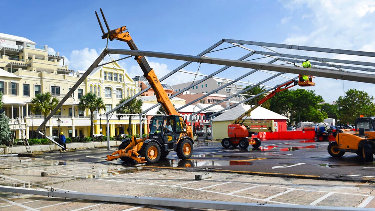 Workers take down a tent frame in preparation for Hurricane Humberto in Hamilton, Bermuda, Wednesday, Sept. 18, 2019. 