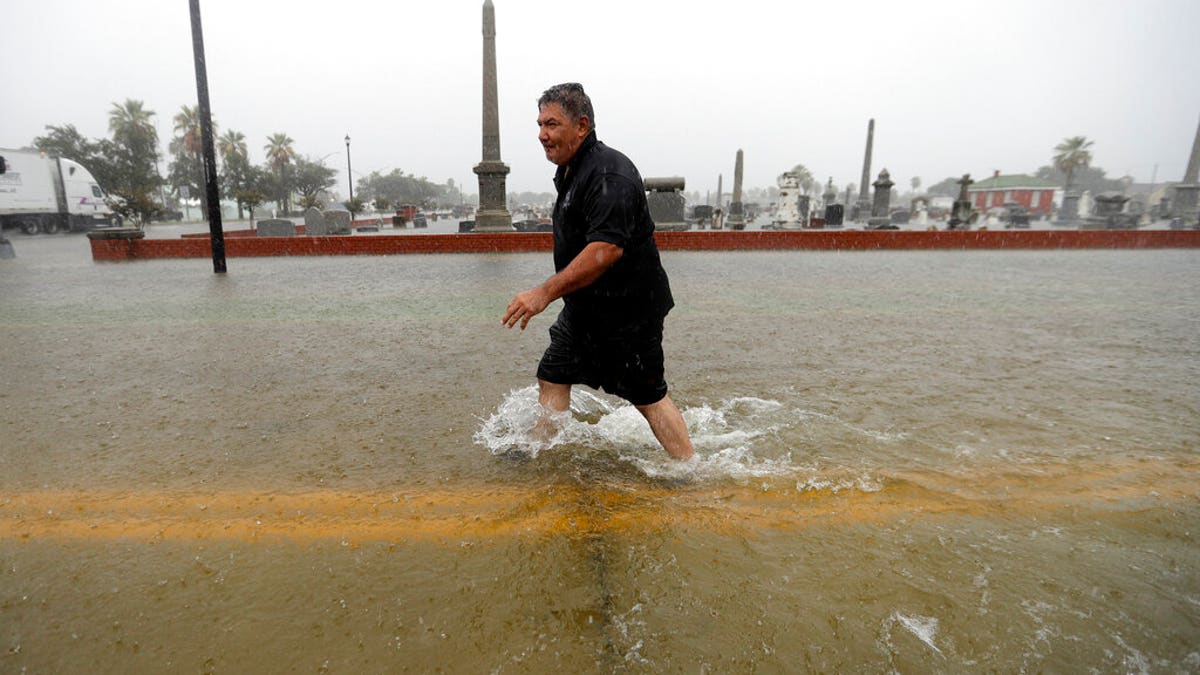Angel Marshman wades through floodwaters from Tropical Depression Imelda after trying to start his flooded car Wednesday, Sept. 18, 2019, in Galveston, Texas. 