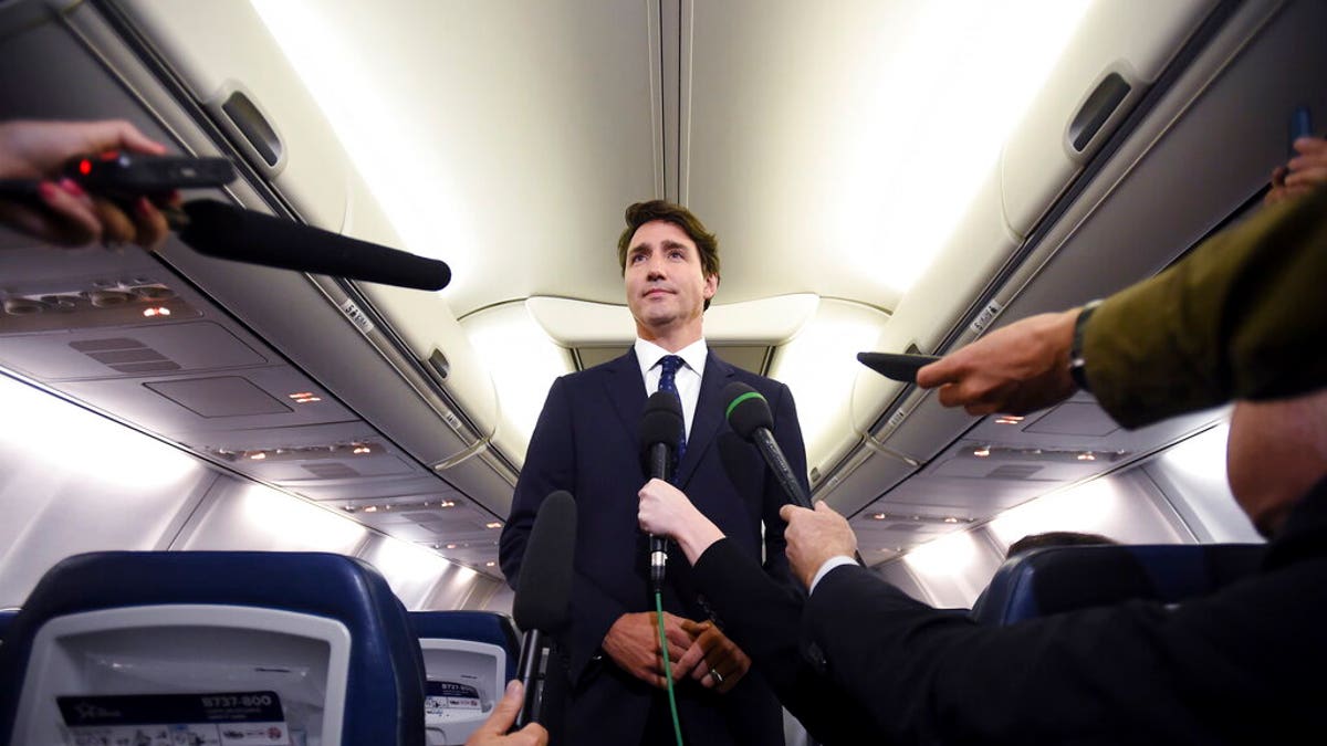 Canadian Prime Minister and Liberal Party leader Justin Trudeau makes a statement in regards to a photo coming to light of himself from 2001, wearing "brownface," during a scrum on his campaign plane in Halifax, Nova Scotia, Wednesday, Sept. 18, 2019.