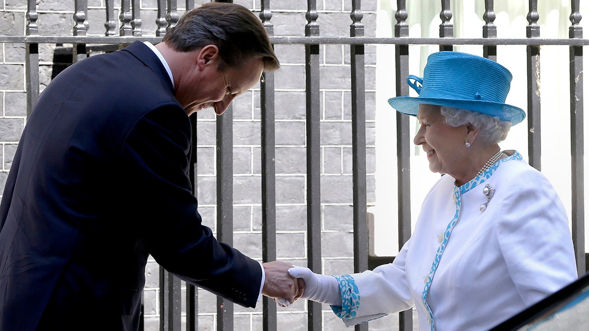 Former PM David Cameron shakes Queen Elizabeth's hand