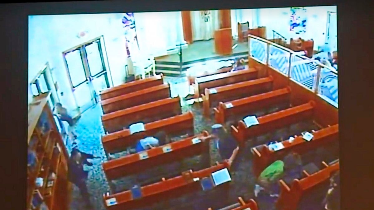 This April 27 photo from surveillance video at the Chabad of Poway shows people diving for cover as a shooting unfolds. (Chabad of Poway/San Diego Superior Court via AP)