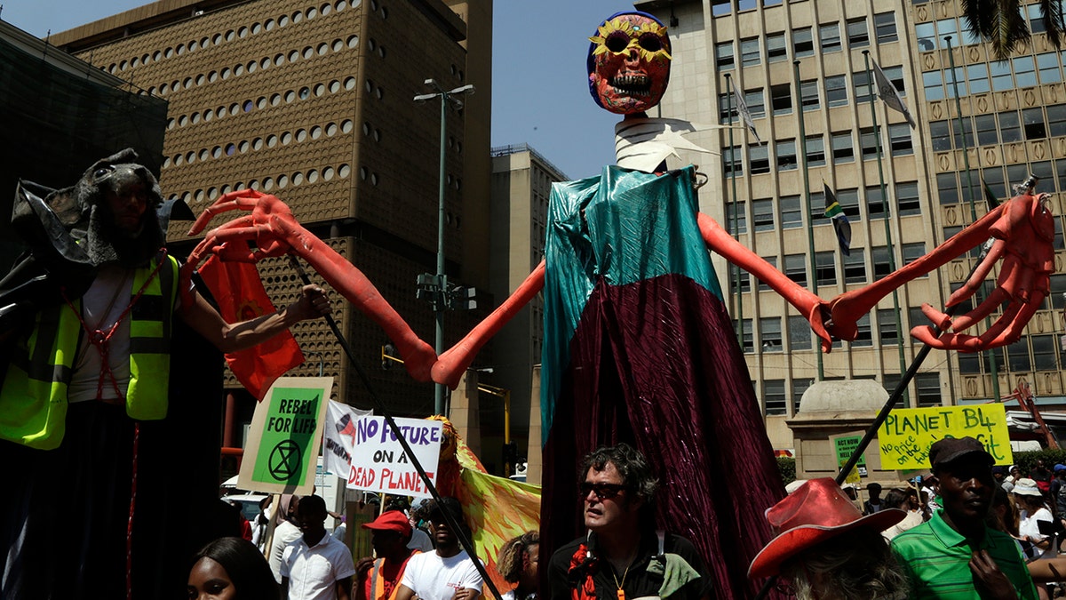 Climate protesters demonstrate outside the local government legislature's offices in Johannesburg, South Africa, Friday, Sept. 20, 2019. Protesters around the world joined rallies on Friday as a day of worldwide demonstrations calling for action against climate change began ahead of a U.N. summit in New York.