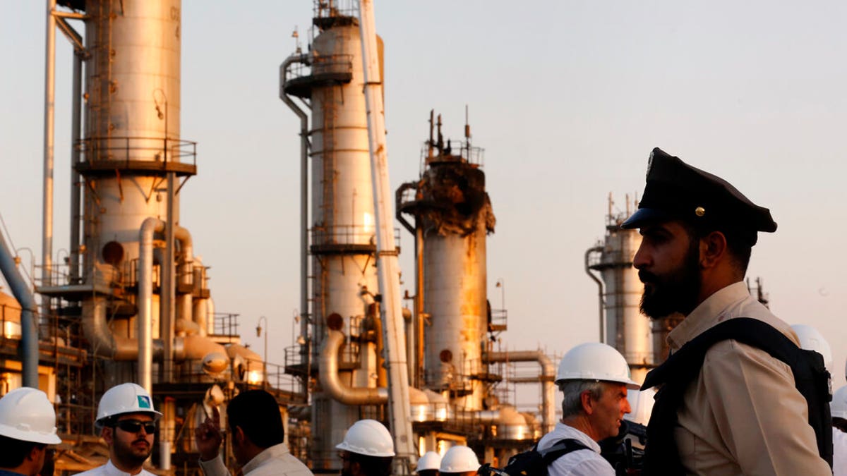 During a trip organized by Saudi information ministry, a security guarder stands alert in front of Aramco's oil processing facility after the recent Sept. 14 attack on Aramco's oil processing facility in Abqaiq, near Dammam in the Kingdom's Eastern Province, Friday, Sept. 20, 2019. 