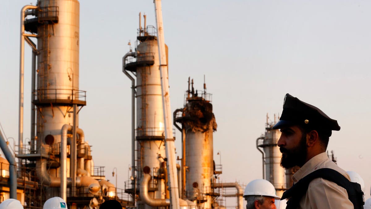 During a trip organized by Saudi information ministry, a security guarder stands alert in front of Aramco's oil processing facility after the recent Sept. 14 attack on Aramco's oil processing facility in Abqaiq, near Dammam in the Kingdom's Eastern Province, Friday, Sept. 20, 2019.