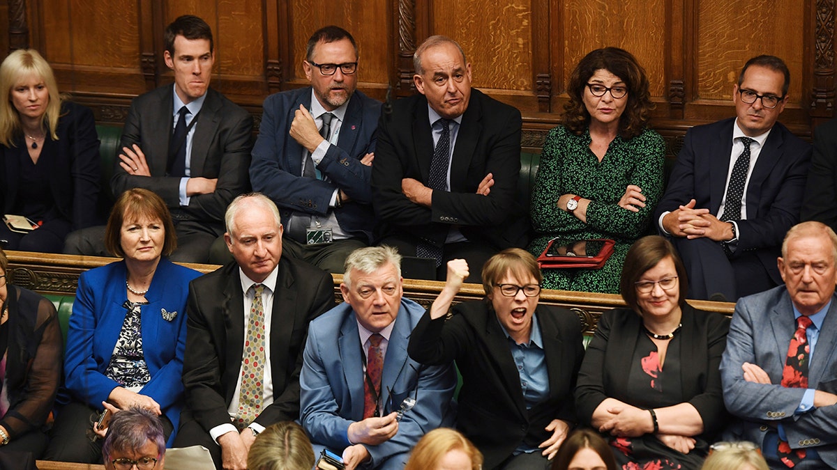 In this handout photo provided by the House of Commons, opposition MP's look on as Britain's General Attorney Geoffrey Cox speaks in Parliament in London, Wednesday, Sept. 25, 2019. 