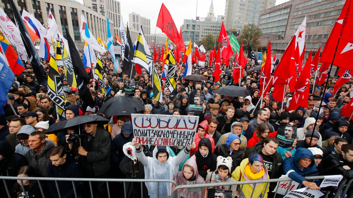 A protester holding a banner reading “Freedom to political prisoners! They haven’t to be arrested!” during a rally to support political prisoners in Moscow.