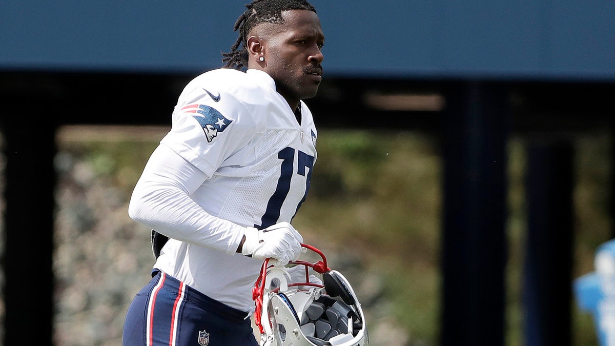 New England Patriots wide receiver Antonio Brown carries his helmet during an NFL football practice in Foxborough, Mass. The Patriots released Brown on  Sept. 20, 2019. (AP Photo/Steven Senne, File)