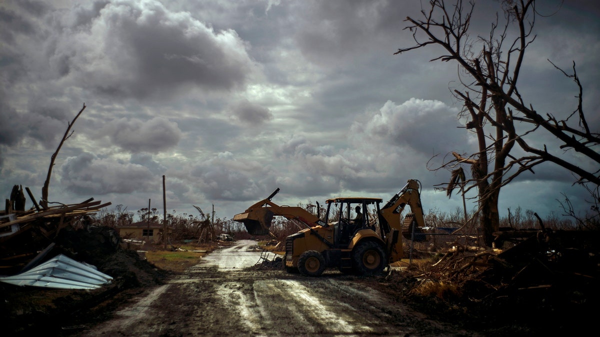 Mos Antenor, 42, drives a bulldozer while clearing the road after Hurricane Dorian Mclean's Town, Grand Bahama, Bahamas, Friday Sept. 13, 2019.