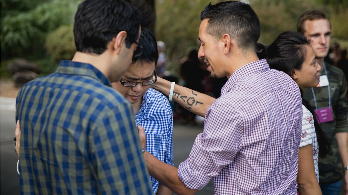 People pray outside Bethel Church in Redding, Calif.