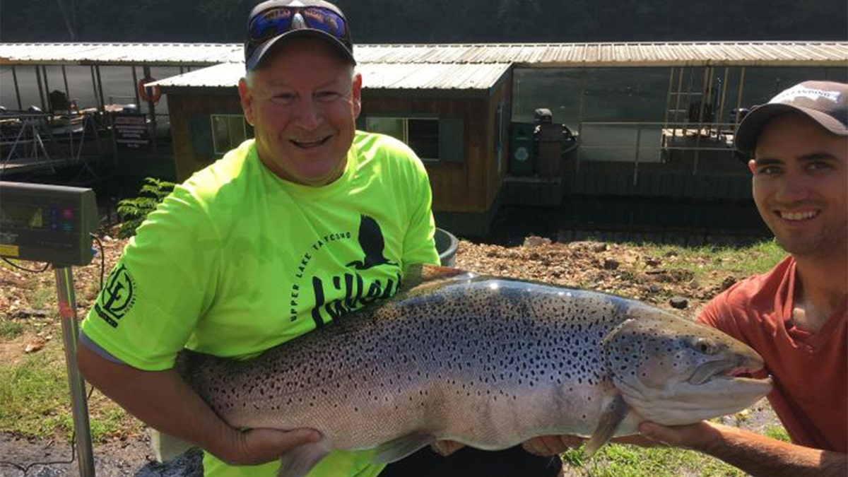 Bill Babler, left, holding the new state-record brown trout with his friend, Ryan Titus. The fish was caught Wednesday at Lake Taneycomo, weighing in at 40 pounds, 6 ounces.