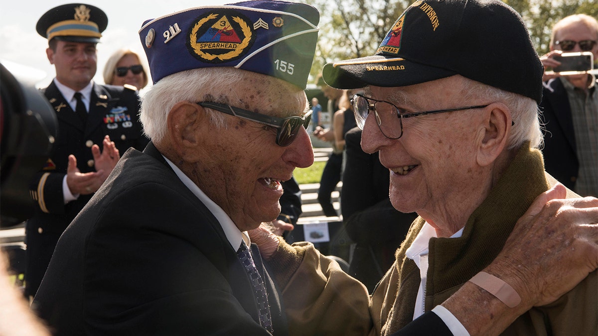 WWII veterans Joe Caserta and Clarence Smoyer embrace each other during the WWII Bronze Star Award Ceremony. (DoD photo by U.S. Navy Petty Officer 2nd Class James K. Lee)