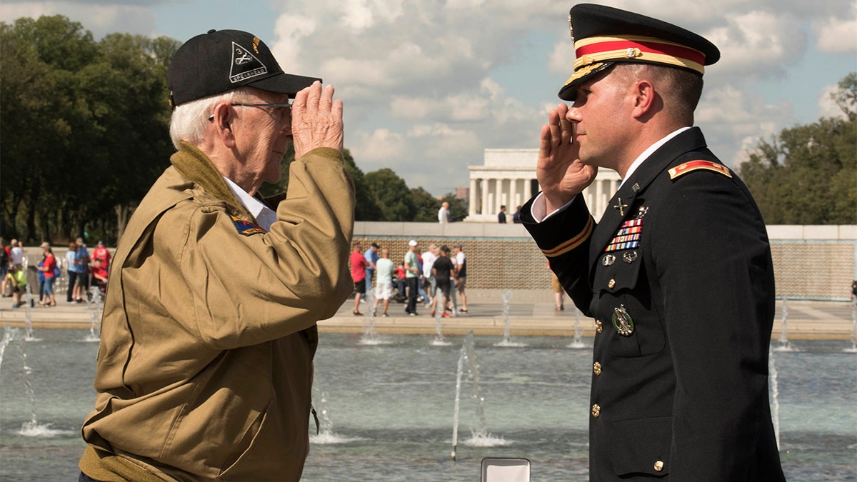 U.S. Army Major Peter Semanoff salutes WWII veteran Clarence Smoyer after awarding him the Bronze Star Medal. (DoD photo by U.S. Navy Petty Officer 2nd Class James K. Lee)