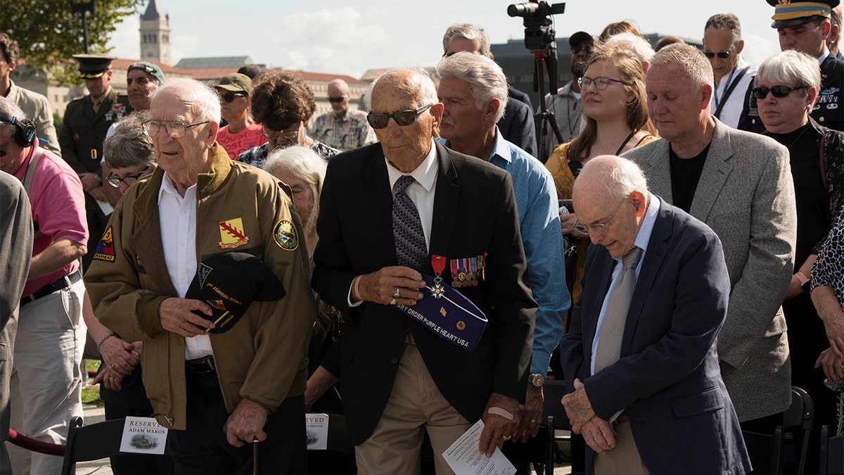WWII veterans Clarence Smoyer, Joe Caserta and Buck Marsh stand for the chaplain's invocation during the WWII Bronze Star Award Ceremony. (DoD photo by U.S. Navy Petty Officer 2nd Class James K. Lee)