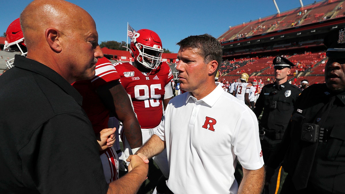 Rutgers head coach Chris Ash, center, shakes hands with head coach Steve Addazio of Boston College after an NCAA college football game on Saturday, Sept. 21, 2019, in Piscataway, N.J. Boston College won, 30-16. (Chris Faytok/NJ Advance Media via AP)