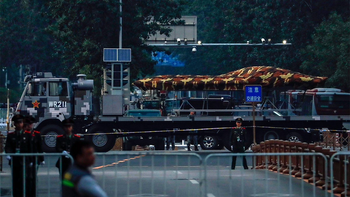 A Chinese military vehicle possibly carrying a drone passing along the Jianguomenwai Avenue last weekend during a rehearsal for the 70th anniversary of Communist China, in Beijing. (AP Photo/Andy Wong)