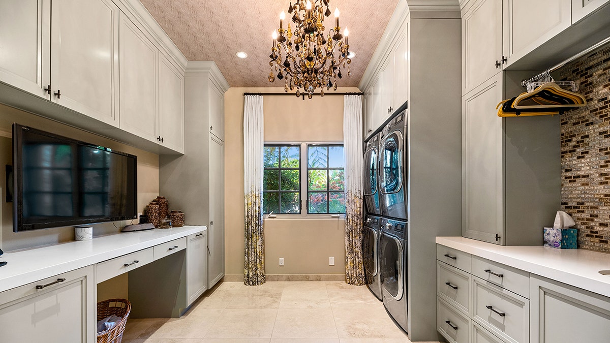 Fancy features include a grand two-story foyer, sweeping staircase, a “top shelf” suite of appliances in the kitchen, home theater, a “tech-bar” room and fireplaces throughout.