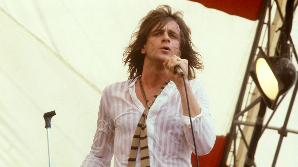 Eddie Money performing on stage.