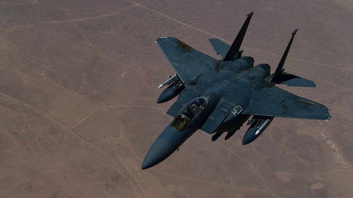 A U.S. Air Force F-15E Strike Eagle descends after receiving fuel from a KC-135 Stratotanker, during an aerial refueling mission at an undisclosed location, Aug. 9, 2019.