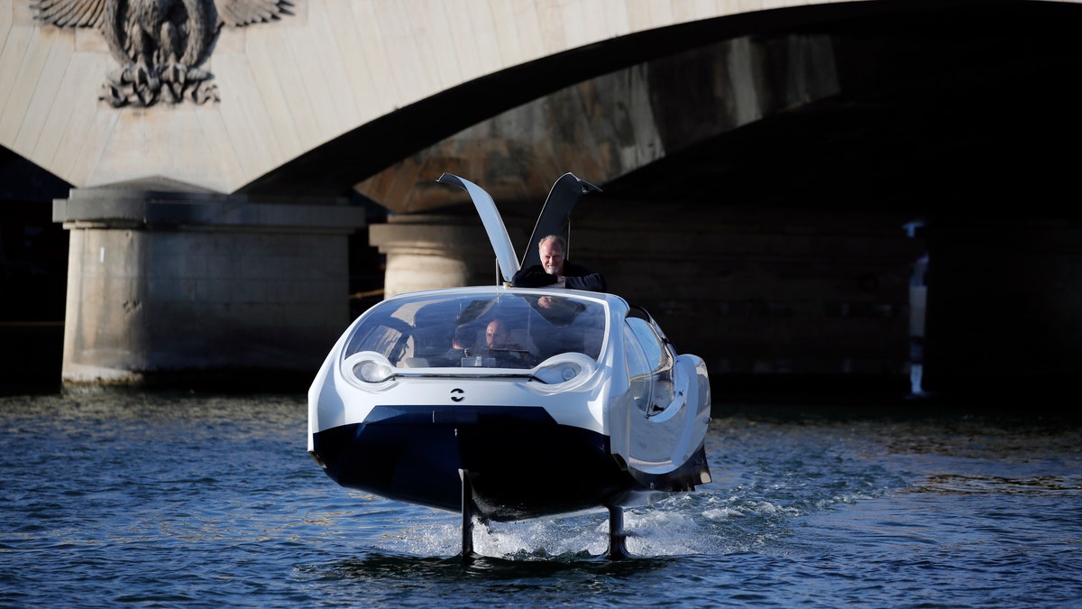 SeaBubbles co-founder Sweden's Anders Bringdal stands onboard a SeaBubble on the river Seine, Wednesday Sept. 18, 2019 in Paris. (AP Photo/Francois Mori)