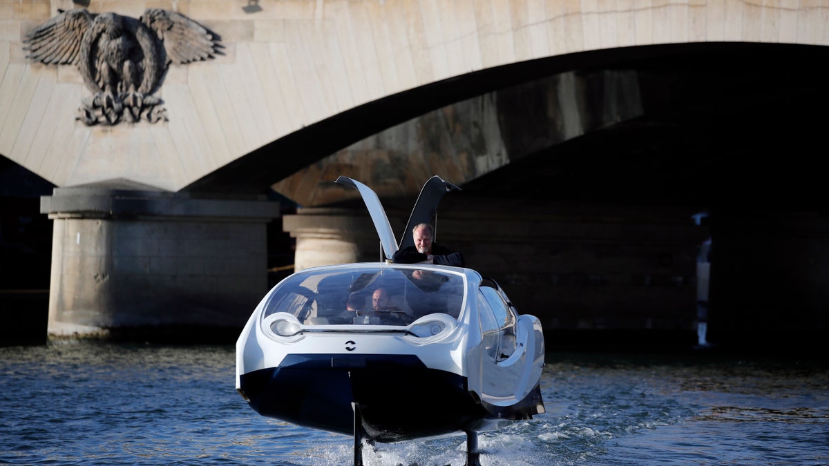 SeaBubbles co-founder Sweden's Anders Bringdal stands onboard a SeaBubble on the river Seine, Wednesday Sept. 18, 2019 in Paris. (AP Photo/Francois Mori)