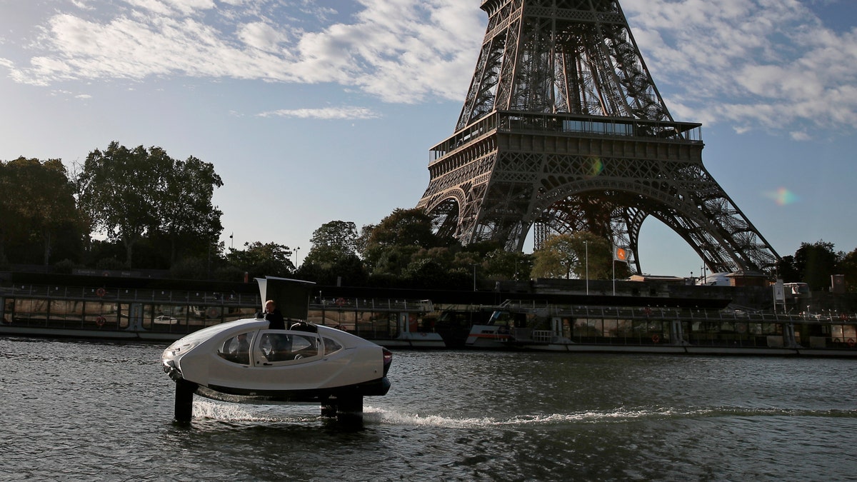 SeaBubbles co-founder Sweden's Anders Bringdal stands onboard a SeaBubble by the Eiffel Tower on the river Seine, Wednesday Sept. 18, 2019 in Paris.