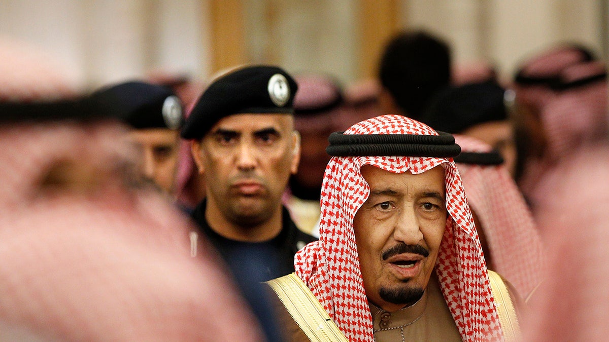 In this Jan. 24, 2015 file photo, Saudi Arabia's King Salman is guarded by his bodyguard Maj. Gen. Abdulaziz al-Fagham, background, as he attends a ceremony at the Diwan royal palace in Riyadh, Saudi Arabia. The 88-year-old King Salman entered the hospital Wednesday for what state media described as "routine examinations."