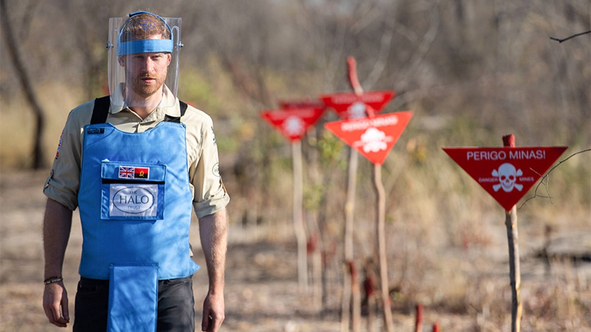 Prince Harry walks through a minefield during a visit to see the work of landmine clearance charity the Halo Trust in Dirico, Angola, on Sept. 27, 2019. 