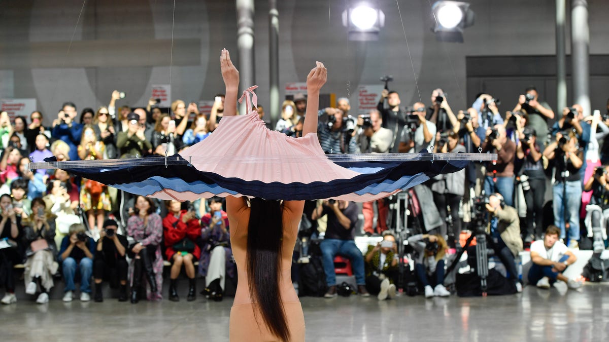 A model on the runway during the Issey Miyake Ready to Wear Spring/Summer 2020 fashion show as part of Paris Fashion Week. The dress was dropped on the model using a pulley system.