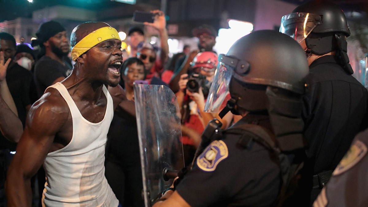 Demonstrators confront police while protesting the acquittal of former St. Louis Police Officer Jason Stockley in St. Louis in September 2017.